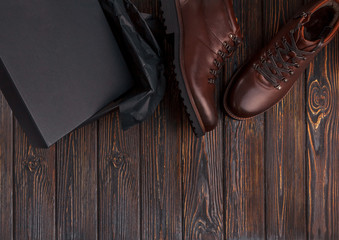 Man's shoes with box on a wooden background