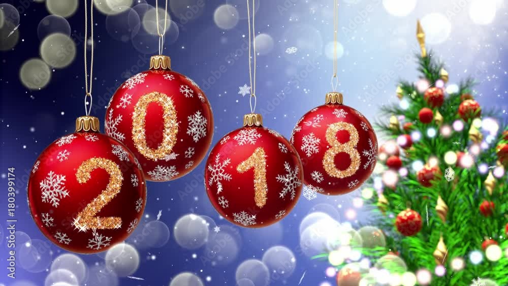 Wall mural red balls with numbers 2018 hanging on the background of a blue bokeh and a rotating christmas tree 