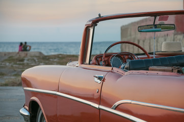 Classic American car in Havana in front of the sea. Cuba 