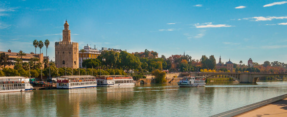 Obraz premium Seville, Spain, Gold tower (torre del oro) in a Seville panoramic view over Guadalquivir river.