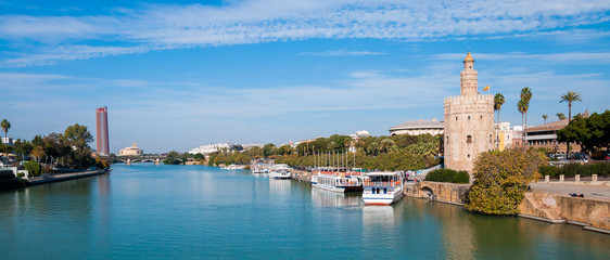 Seville, Spain, Gold tower (torre del oro) in a Seville panoramic view over Guadalquivir river.