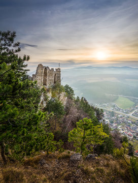 Ruins of a Castle on a Rockface in Gleissenfeld, Austria with Mountains and Village in Background. Located in Nature Park Seebenstein-Turkensturz.