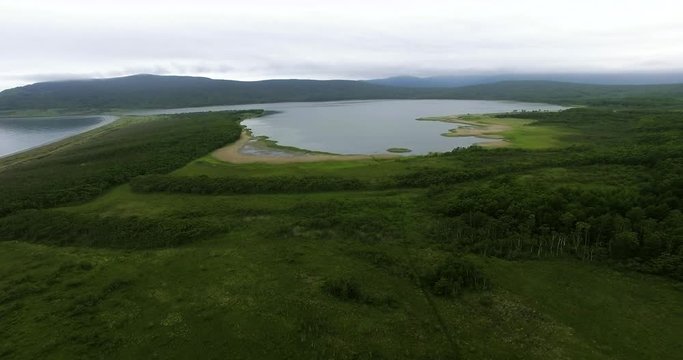 Descending aerial view of the birdman house near lake Blagodatnoye at the Sikhote-Alin Nature Reserve in Russian Far East. It has been inscribed on the UNESCO World Heritage List since 2001.