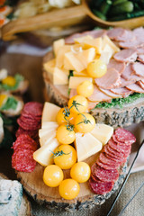 decorated catering banquet table with chips, cheese and yellow tomato