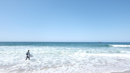 Fototapeta na wymiar Surfers in the sea