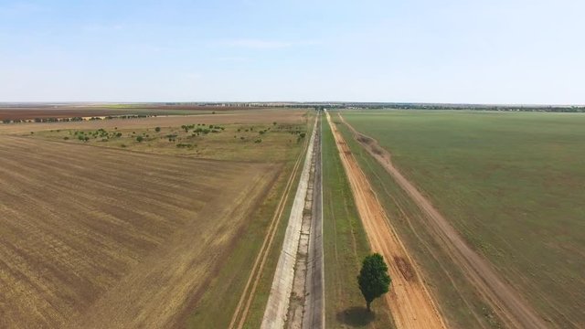 Irrigation water channel, aerial video / Flying over inoperative irrigation canal, aerial video, drone point of view
