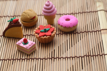 Miniature people :  Male and female traveler miniature figures with dessert , donut