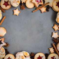 Obraz na płótnie Canvas Ginger homemade cookies with strawberry jam on gray concrete background with Christmas tree. View with copy space. Flat lay, top view. Christmas Border - horizontal banner. Web size. stars.