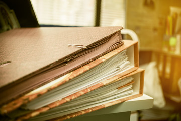 Many Stacks of document folders in office for Annual Report files on Abstract blurred photo of businessman hands working with laptop computer. business busy concept