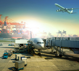 cargo plane loading commercial goods against large logistic ,shipping port background