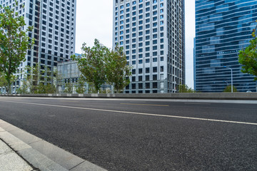 Obraz premium empty road and modern office block buildings against sky, china.