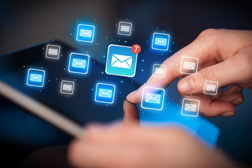 Fingers touching tablet with mail