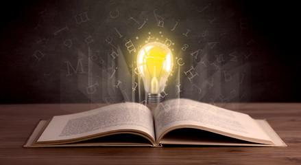 Letters and lightbulb over book