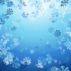 Falling snowflakes over bright blue background