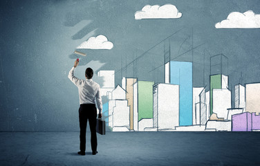 Salesman painting tall buildings on urban wall