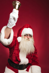 santa claus ringing his bell with hand in the air