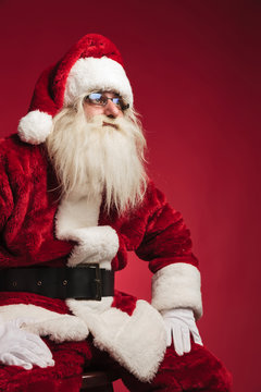 cutout side image of santa claus sitting on a chair