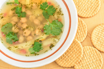 Pea soup with potatoes and crackers