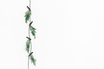 Christmas composition. Christmas garland made of conifer tree branches on white background. Flat...