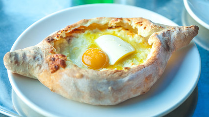 Adjarian khachapuri with eggs on the table