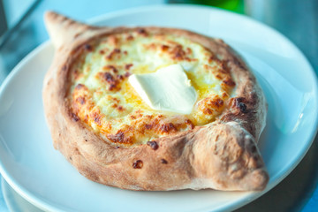 Adjarian khachapuri with eggs on the table