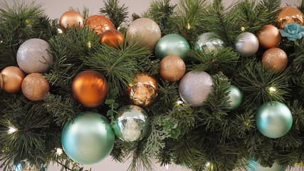 Obraz na płótnie Canvas Faux lit Christmas tree branch style decoration with balls and flowers