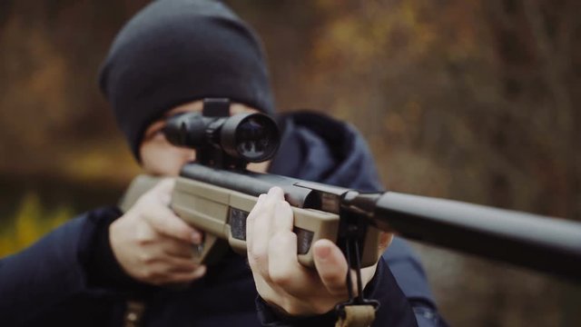 Man shooting gun in forest