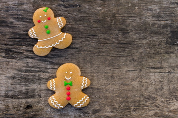 Christmas gingerbread couple cookies on rustic wooden table