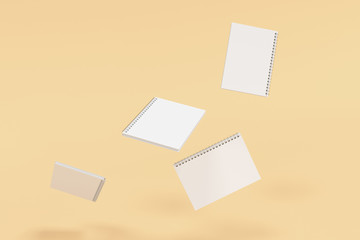 Four notebooks with spiral bound on orange background