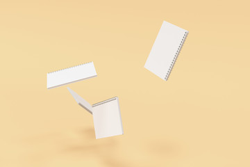 Four notebooks with spiral bound on orange background