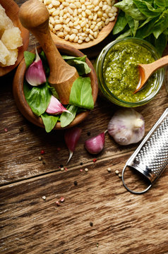 Top view of Pesto sauce ingredients and utensils on wood table