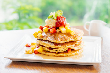 Stack of pancake with strawberry on top