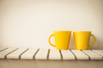 Yellow coffee cup on table