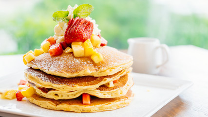 Stack of pancake with strawberry on top