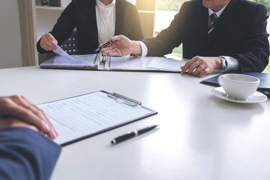 Interviewer or Board reading a resume during a job interview, Employer interviewing a young male job seeker for recruitment talking in modern office, employment and recruitment concept