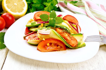 Salad with zucchini and tomato on light board