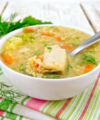 Soup fish with millet and spoon on white board
