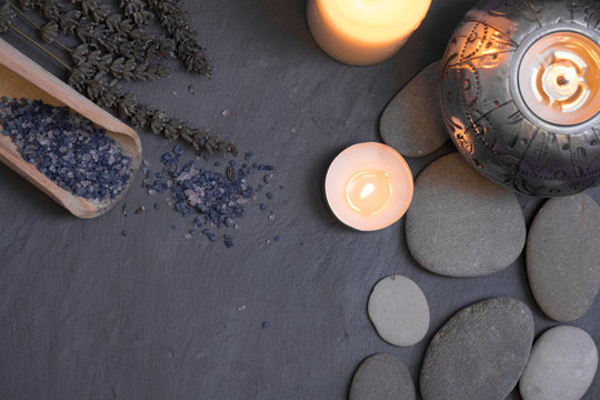spa and wellness still life composition with candles and pebble stones