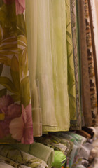 Assortment of beautiful curtain hanging samples in shop fabric upright close up, shooting angle
