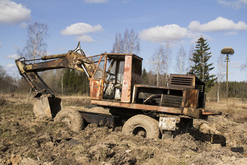 Fototapeta premium The image of the tractor stuck in the mud
