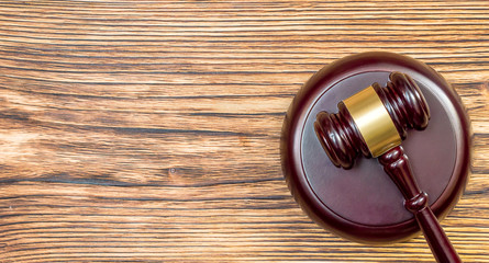 Wooden gavel with stand on wooden table. Top view. Justice concept.