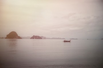 Beach scenery with the islands boat in the cloudy day with the lonely mood and copy space for text design