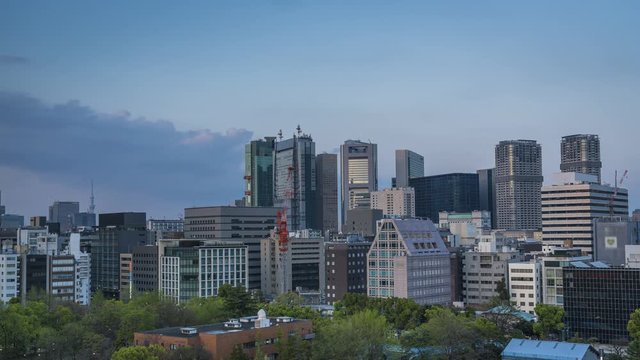 Tokyo city skyline with business skyscrapers in Minato district, Japan. Time lapse with sunset light