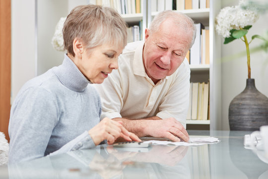 Senioren Paar rechnet mit Taschenrechner