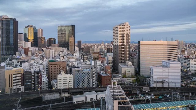 Shinjuku city skyline with business skyscrapers and metro system in Tokyo, Japan. High angle time lapse with sky and subway trains
