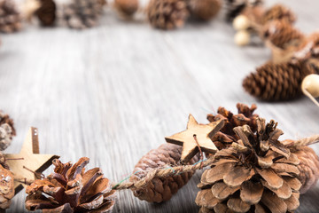 Fototapeta na wymiar pine cone on a white wooden background for christmas