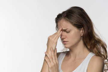 Young girl experiencing headache or depression and mourned over white background