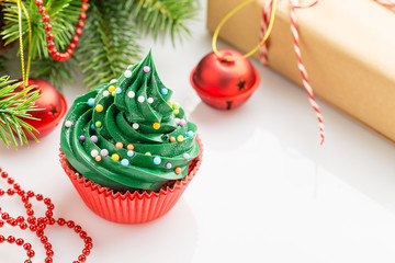 Christmas green cupcake in red cup with decorations