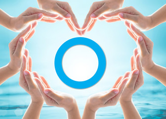 World diabetes day concept with blue circle symbolic logo among protective heart-shape hands for...