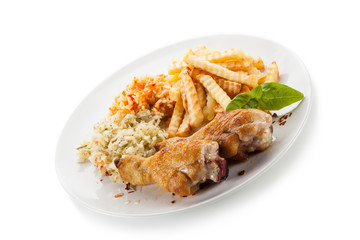 Grilled drumsticks with french fries and vegetables on white background